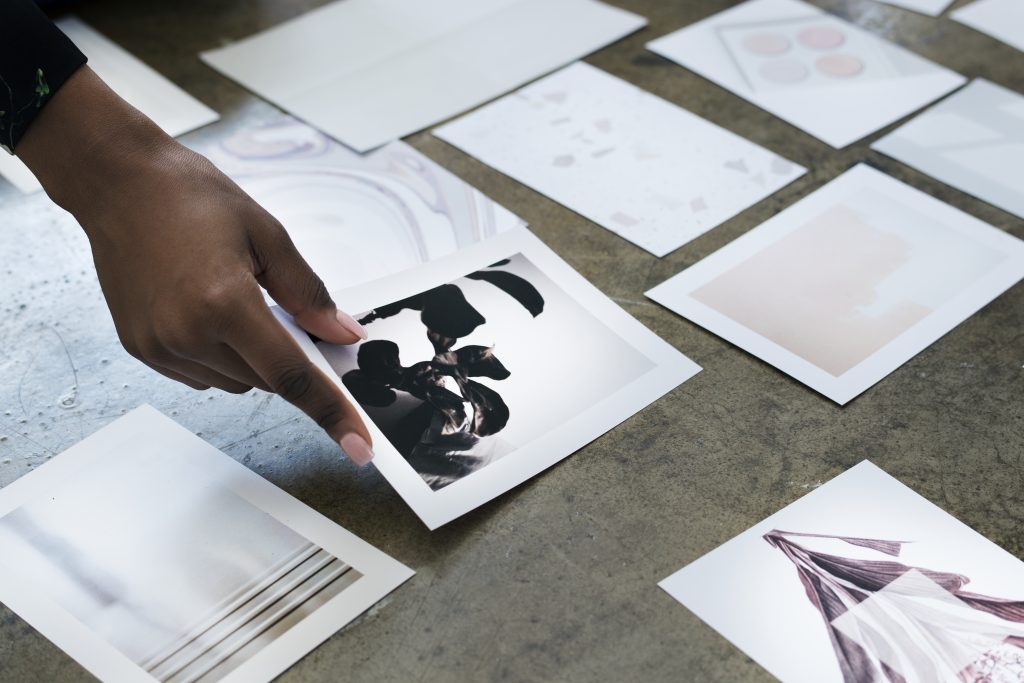 designer laying out images on the floor