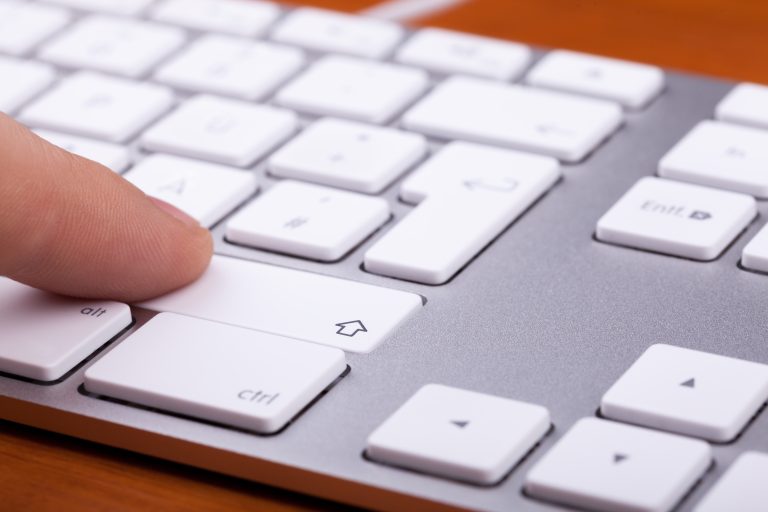 Finger pressing shift key on a mac keyboard